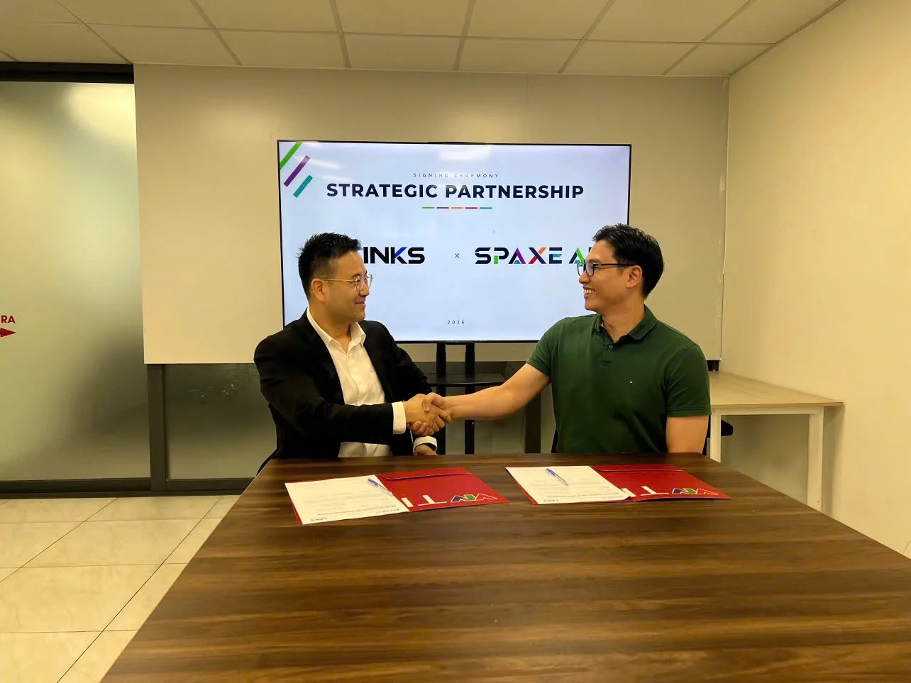 Representatives from Links Inc. and SPAXE AI shaking hands after signing